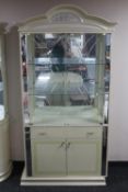 A cream high gloss double door display cabinet fitted cupboards and drawer beneath