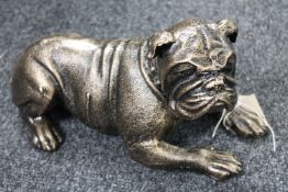 A cast iron figure of a lying bulldog