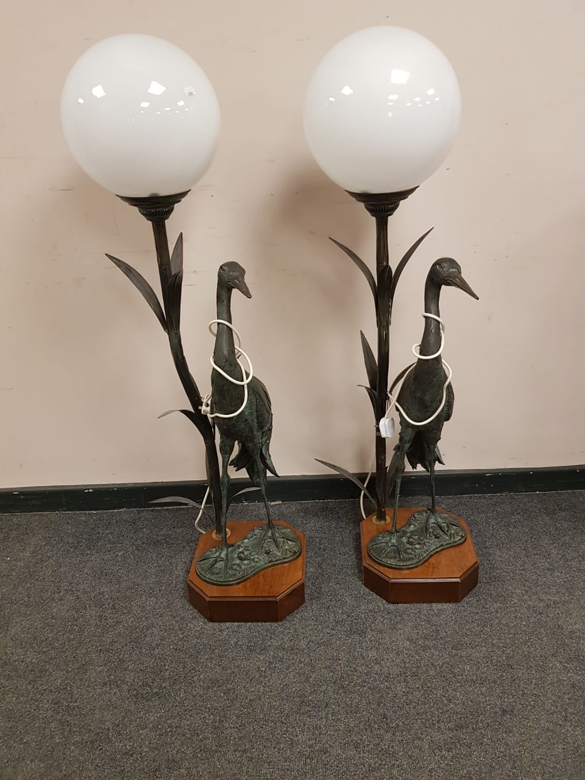 A pair of patinated brass figural lamps, modelled as storks,