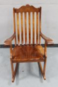 An eastern hardwood brass inlaid rocking chair