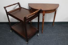 An inlaid mahogany D-shaped hall table together with a mahogany two tier tea trolley with lift off