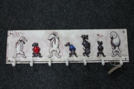 A cast iron seven hook wall rack,