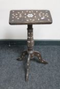 An antique mother of pearl inlaid pedestal table