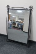 A contemporary wrought iron framed mirror