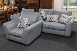 A three piece lounge suite upholstered in a blue fabric together with five scatter cushions