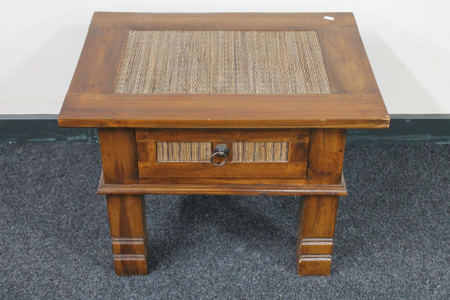 A contemporary hardwood lamp table with rattan insert