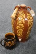 An antique slipware glazed pottery keg by Wetheridge of Penrith and a glazed pottery jug