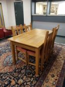 A good quality oak extending dining room table with four chairs,