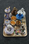 A tray containing two stoneware decanters, continental figures, china flower posy,