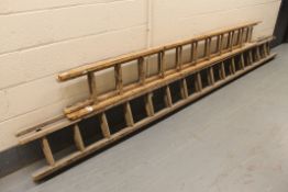 Two sets of wooden extension ladders