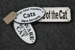 Three cast iron cat signs