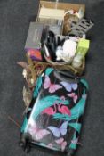 A luggage case and two boxes containing dried flowers, Christmas toys, novelty items,