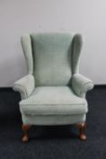 A mid 20th century armchair upholstered in a green dralon