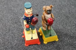 A cast iron Popeye mechanical boxer together with a similar boxer dog