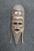 A carved hardwood tribal mask