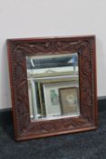 A carved Eastern hardwood wall mirror