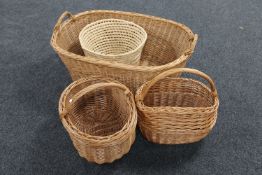 A large wicker twin handled log basket and three further baskets