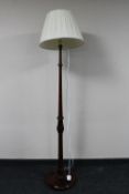 An antique stained beech standard lamp with shade