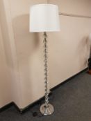 A contemporary glass stemmed floor lamp,