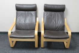 A pair of beech framed brown leather upholstered relaxer armchairs