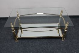 A contemporary brass framed glass topped coffee table with mirrored undershelf