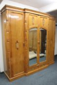 An impressive oriental style parcel gilt breakfront wardrobe