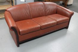 A late 20th century Danish brown leather three seater settee