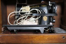 A cased mid 20th century Singer sewing machine