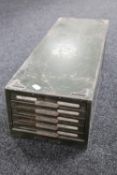 An industrial metal desk top five drawer index chest