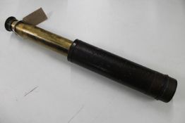 An antique brass leather bound nautical telescope