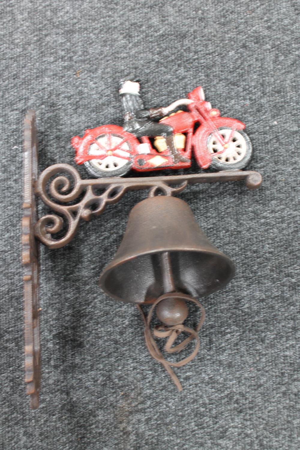 A cast iron vintage motorcycle wall bracket with bell