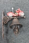 A cast iron vintage motorcycle wall bracket with bell