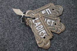 Three cast iron Art Deco toilet plaques