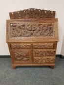 A profusely carved hardwood Indian bureau,