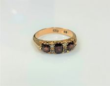 An 18ct gold diamond and garnet ring, size N CONDITION REPORT: 4.