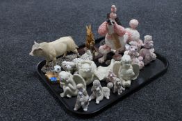 A tray containing cherub figures, a Sheratt and Simpson Bull,