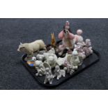 A tray containing cherub figures, a Sheratt and Simpson Bull,