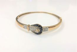 A 9ct gold diamond and sapphire set hinged bangle,