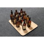 Eleven early 20th century brown glass chemist's bottles with stoppers bearing labels