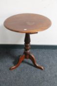 A Victorian mahogany occasional table on three way pedestal