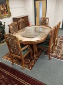 A profusely carved hardwood Indian extending dining table, together with six chairs,