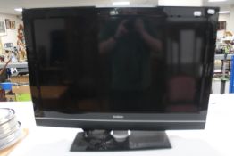 A Goodmans 32" LCD TV together with a boxed 28cl stainless steel stock pot and a table lamp