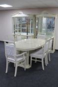 A cream high gloss oval extending dining table together with a set of six chairs