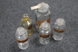 Five antique glass chemist's bottles with stoppers bearing labels