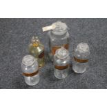 Five antique glass chemist's bottles with stoppers bearing labels