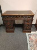 A Victorian heavily carved oak twin pedestal desk,