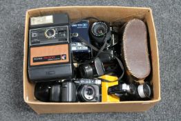 A box of assorted cameras, lenses,