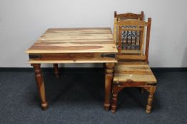 A sheesham wood table with two chairs