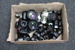 A box of thirteen SLR cameras with lenses