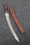 An African sword in leather scabbard